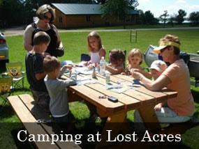 Family eating at picnic table at campgrounds at Lost Acres